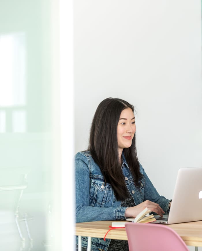 A woman on a video call at her laptop