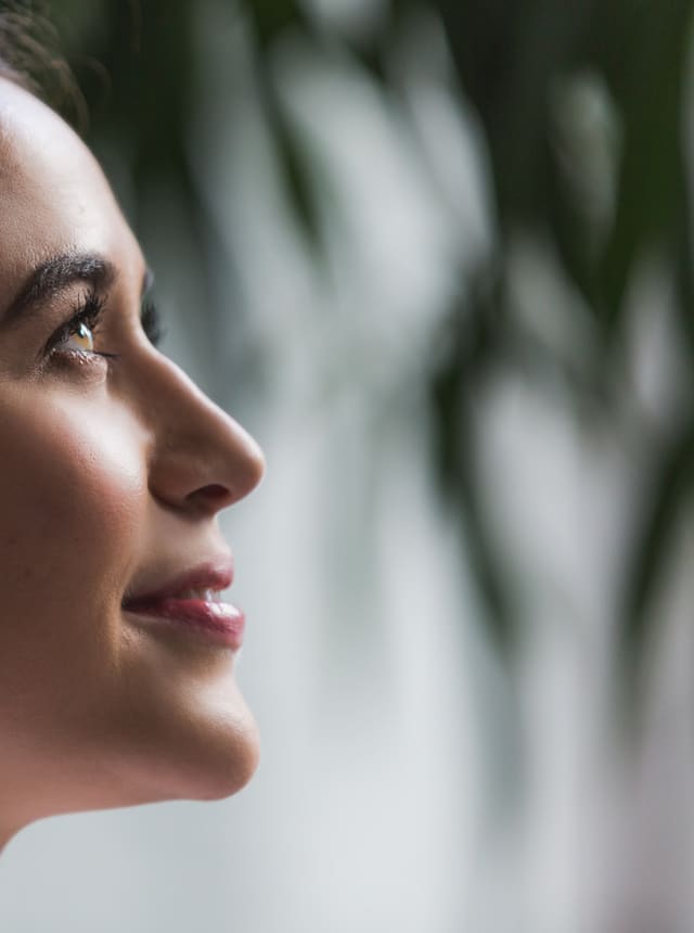 A woman in profile, smiling calmly