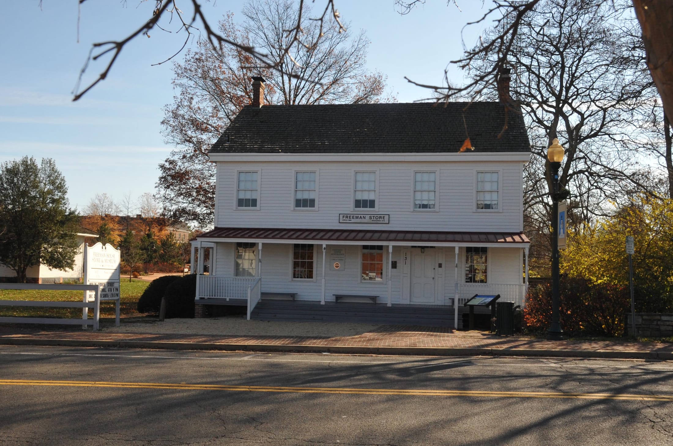 The white clapboard Freeman Store on Church Street in Vienna, under autumn trees