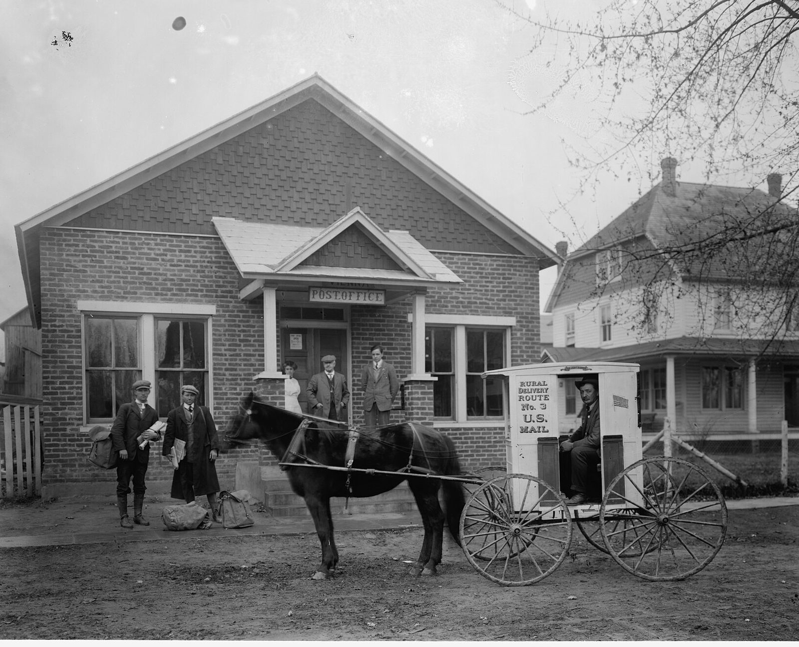 An early twentieth-century photograph of Vienna's post office, with a horse and buggy outside