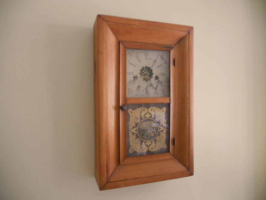 An antique wooden wall clock