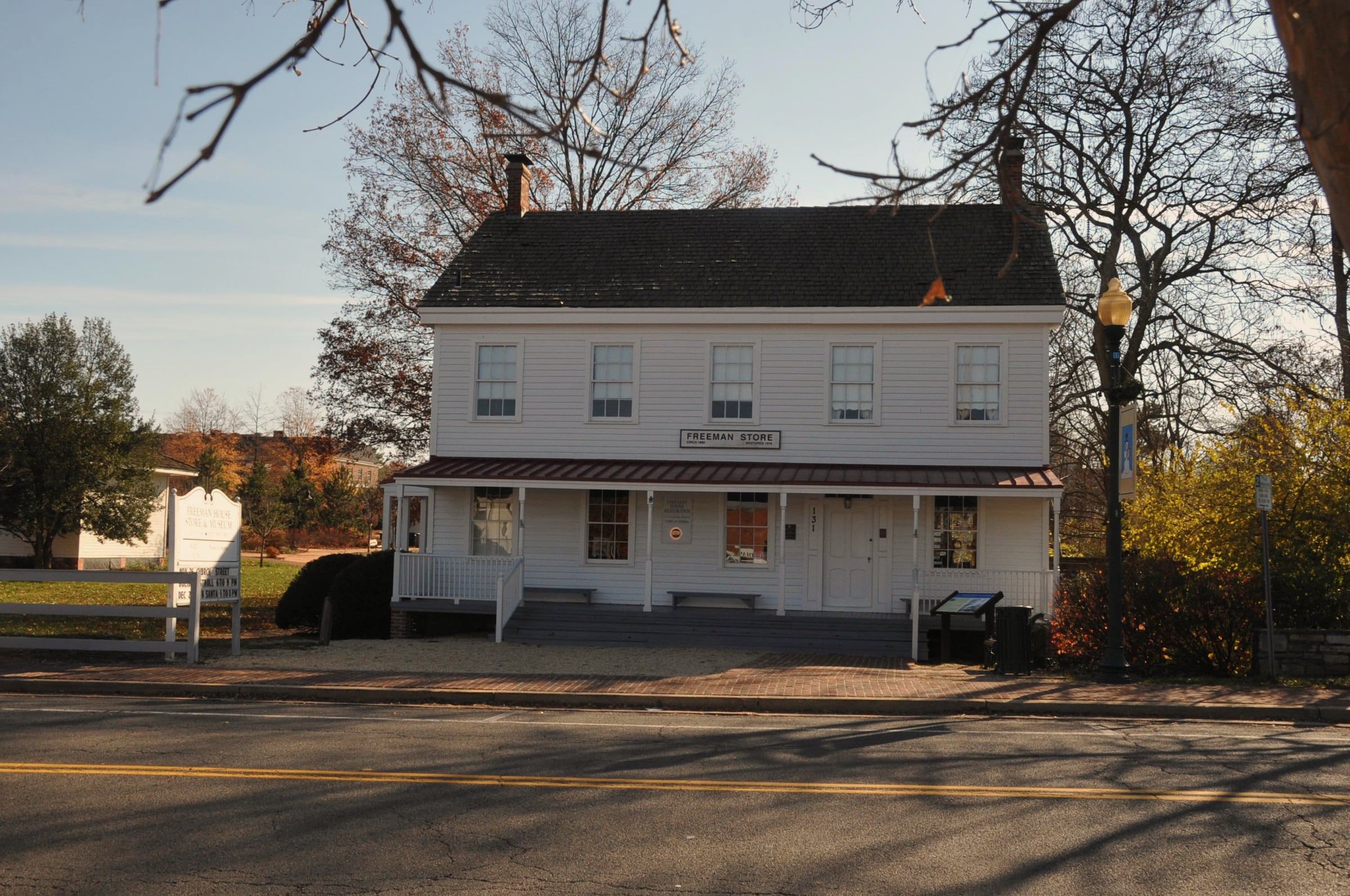 The white clapboard Freeman Store on Church Street in Vienna, under bare autumn trees